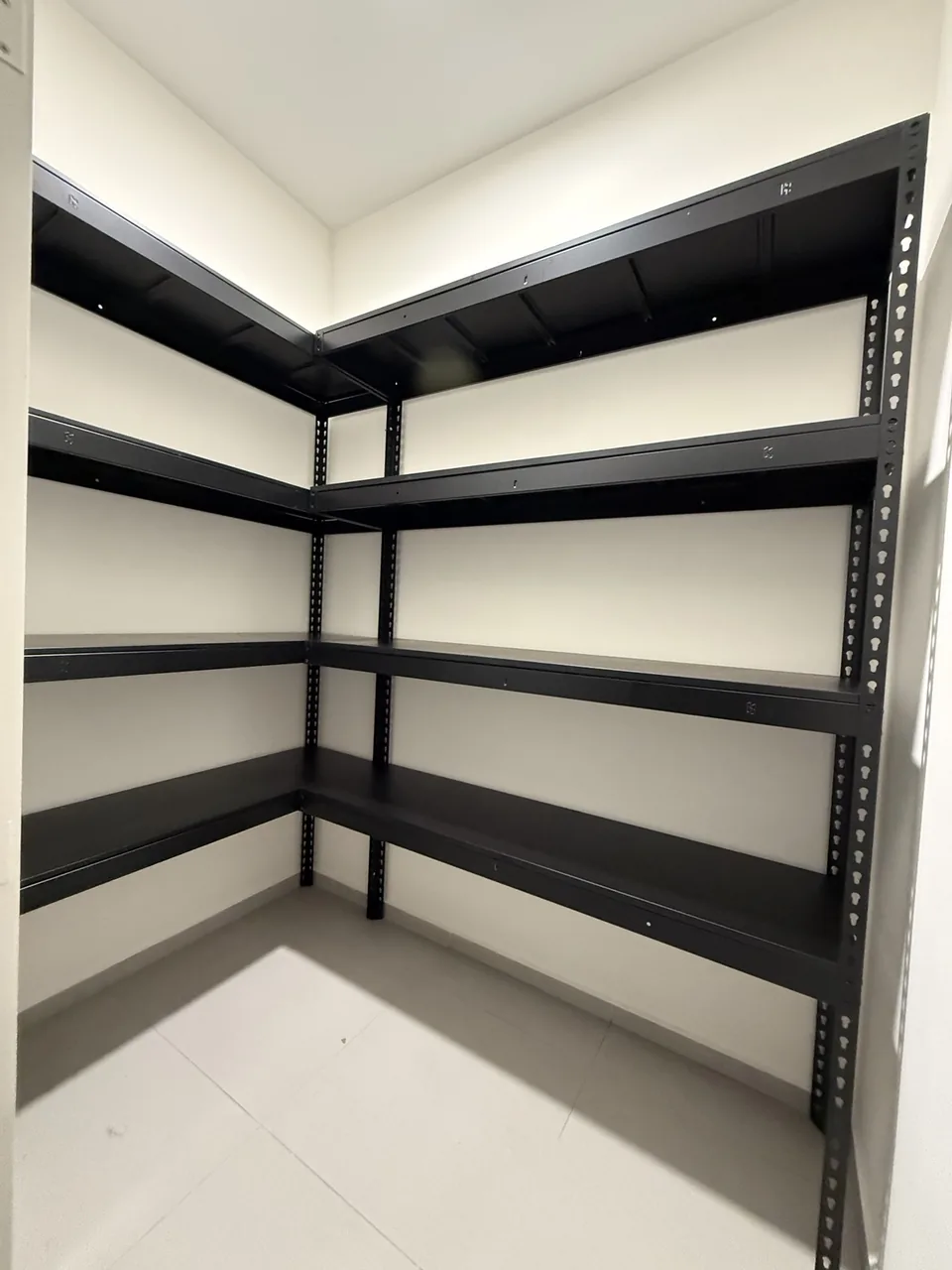 Black four-tier L-shaped shelving with open corner access